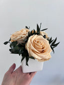 Close view of the peach preserved roses and eucalyptus in the Camille arrangement