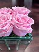 Mirror Rose arrangement on a dark wooden table