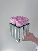 The small mirrored cube of the Mirror Rose duo, held in one hand