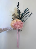 Noelle bouquet held out to the side, showing its pampas and eucalyptus stems