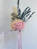 Side view of the Noelle bouquet with trailing pink ribbon