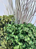 Close view of green preserved hydrangea and dried branches in the Eden arrangement