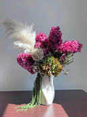 Sienna preserved arrangement standing on a dark wooden table