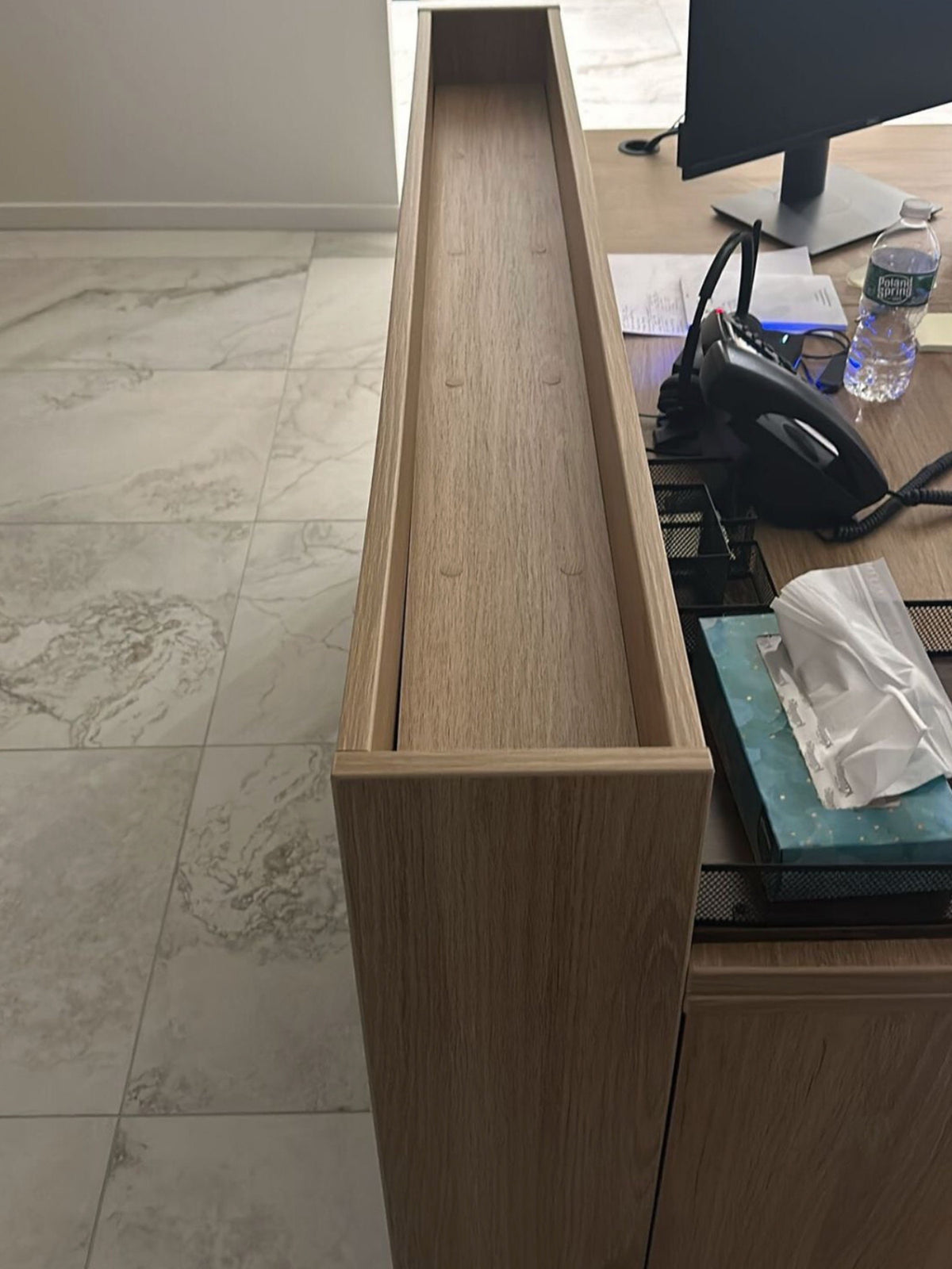 Before: an empty wood planter box between the desks at Energy Plus