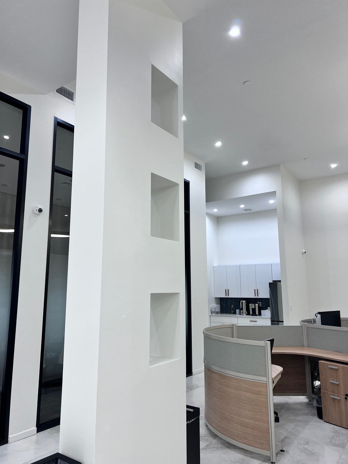Before: the empty wall niches beside reception at Energy Plus