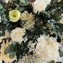 White and green preserved roses with eucalyptus and rice flowers, close up
