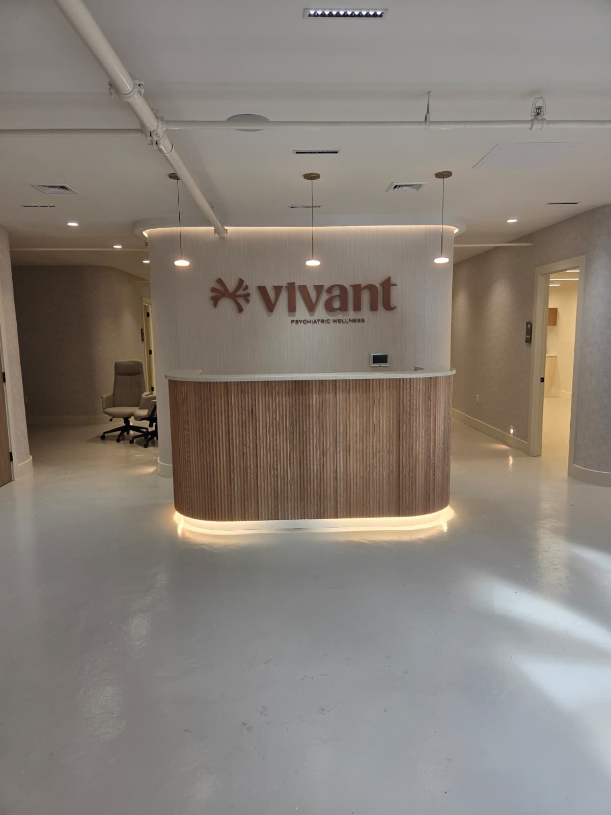 Before: the Vivant Mind reception seen head-on, the desk bare