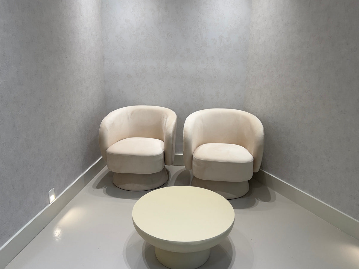 Before: two cream chairs and a round table in an empty Vivant Mind waiting corner